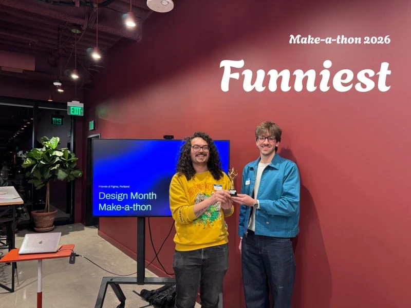Scott and Milo holding a small gold trophy in front of a red wall, with a Make-a-thon 2026 Funniest title over the photo